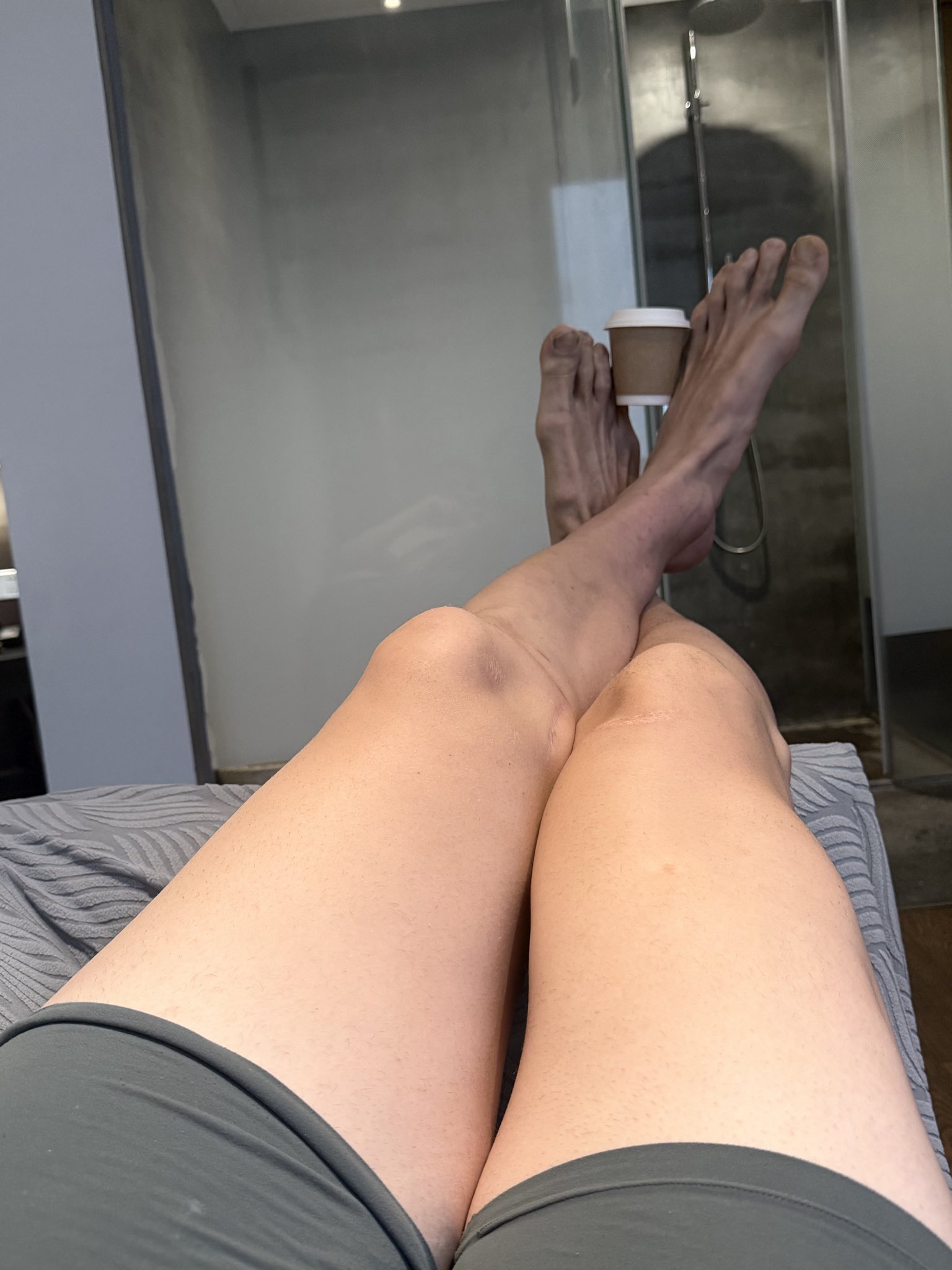 Coffee cup between alpha feet 